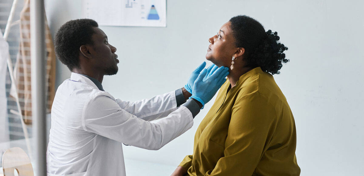 doctor examing a patients lymph nodes