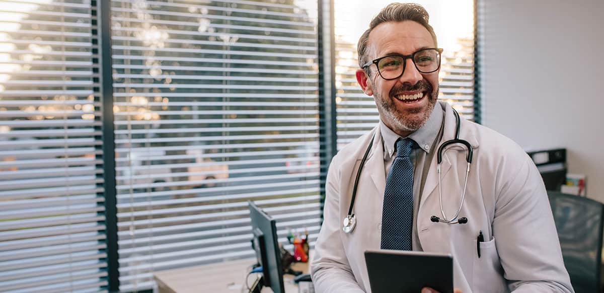 doctor in office smiling